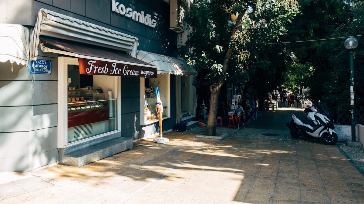 people walking on sidewalk near store during daytime